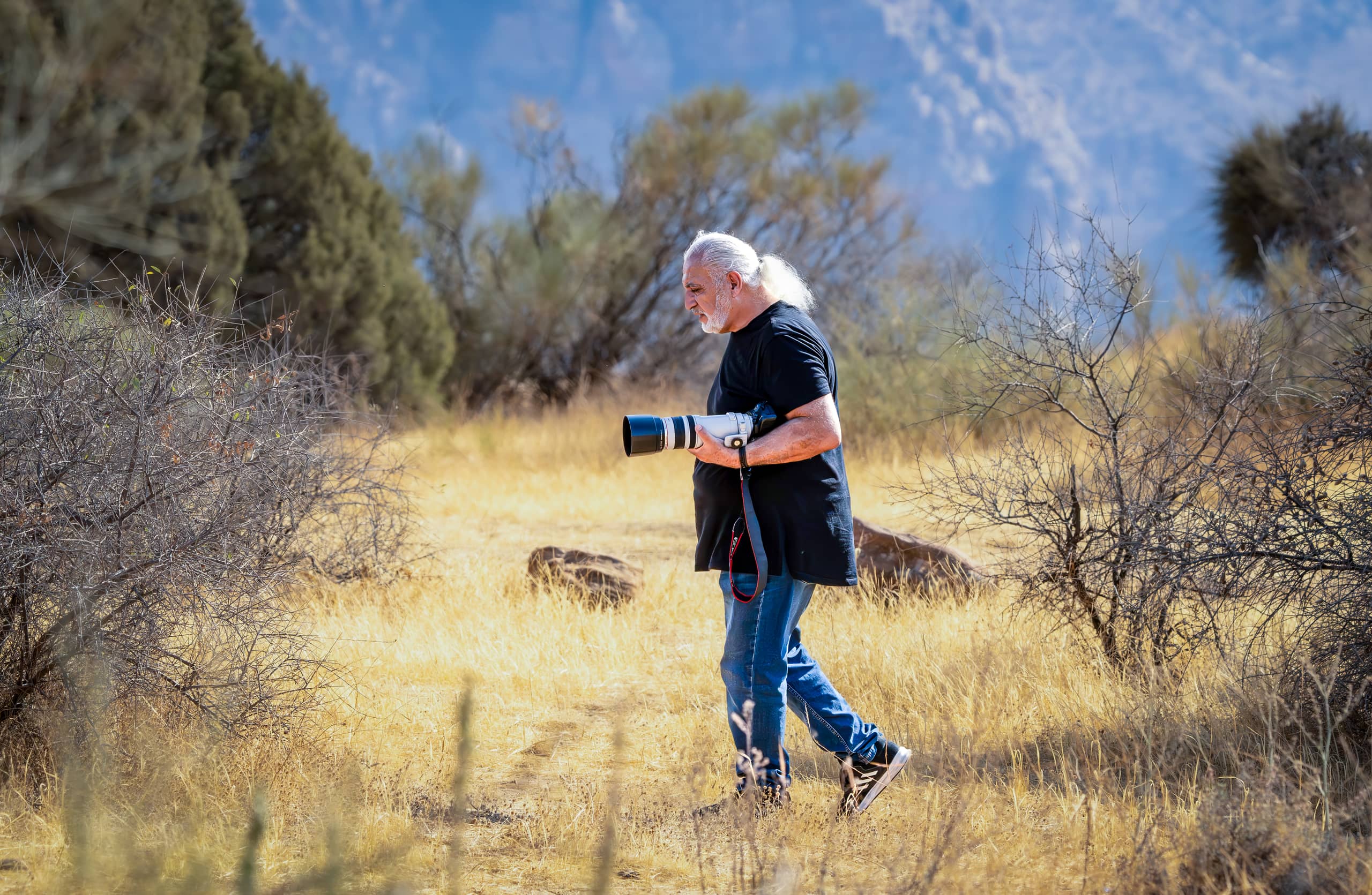 Photographer Walking Danah Camera, a fine-art photograph by Ali Abu Ras