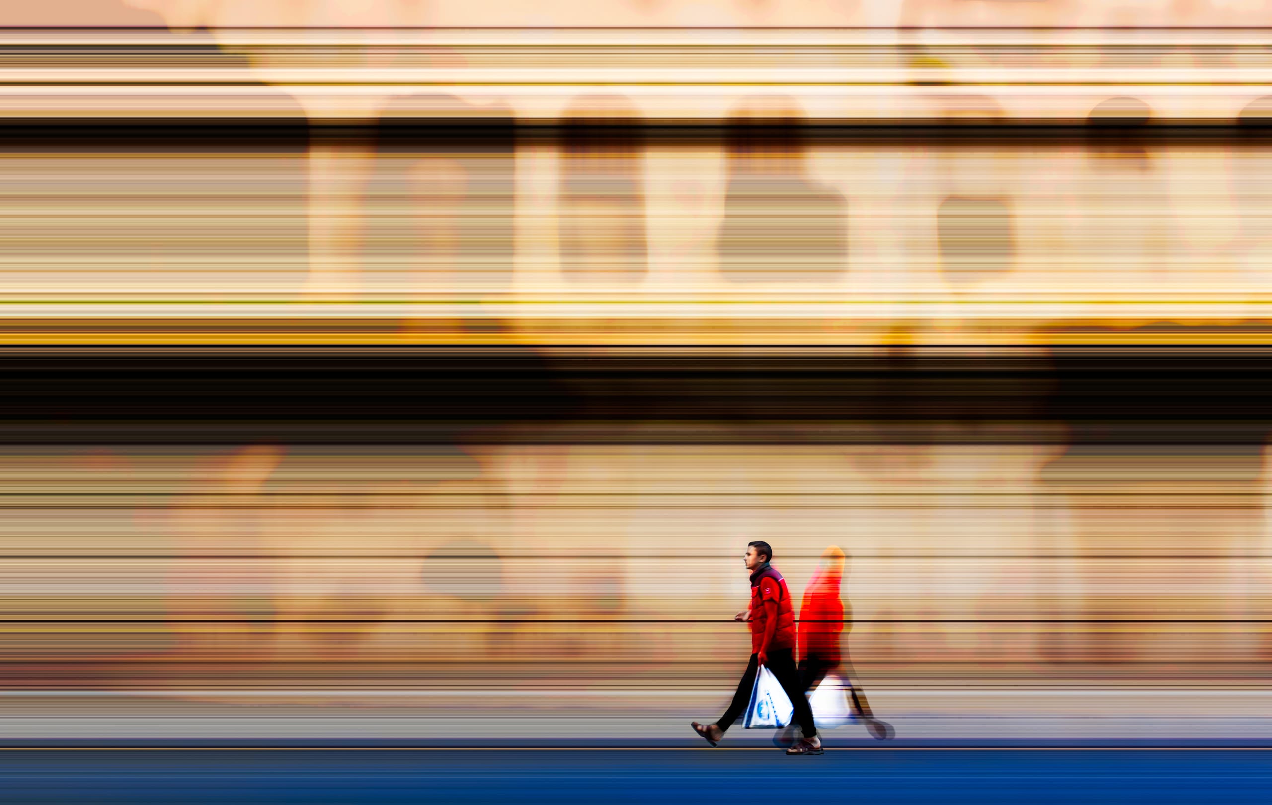 Fine ART MAN Walking IN Center City RED, a fine-art photograph by Ali Abu Ras