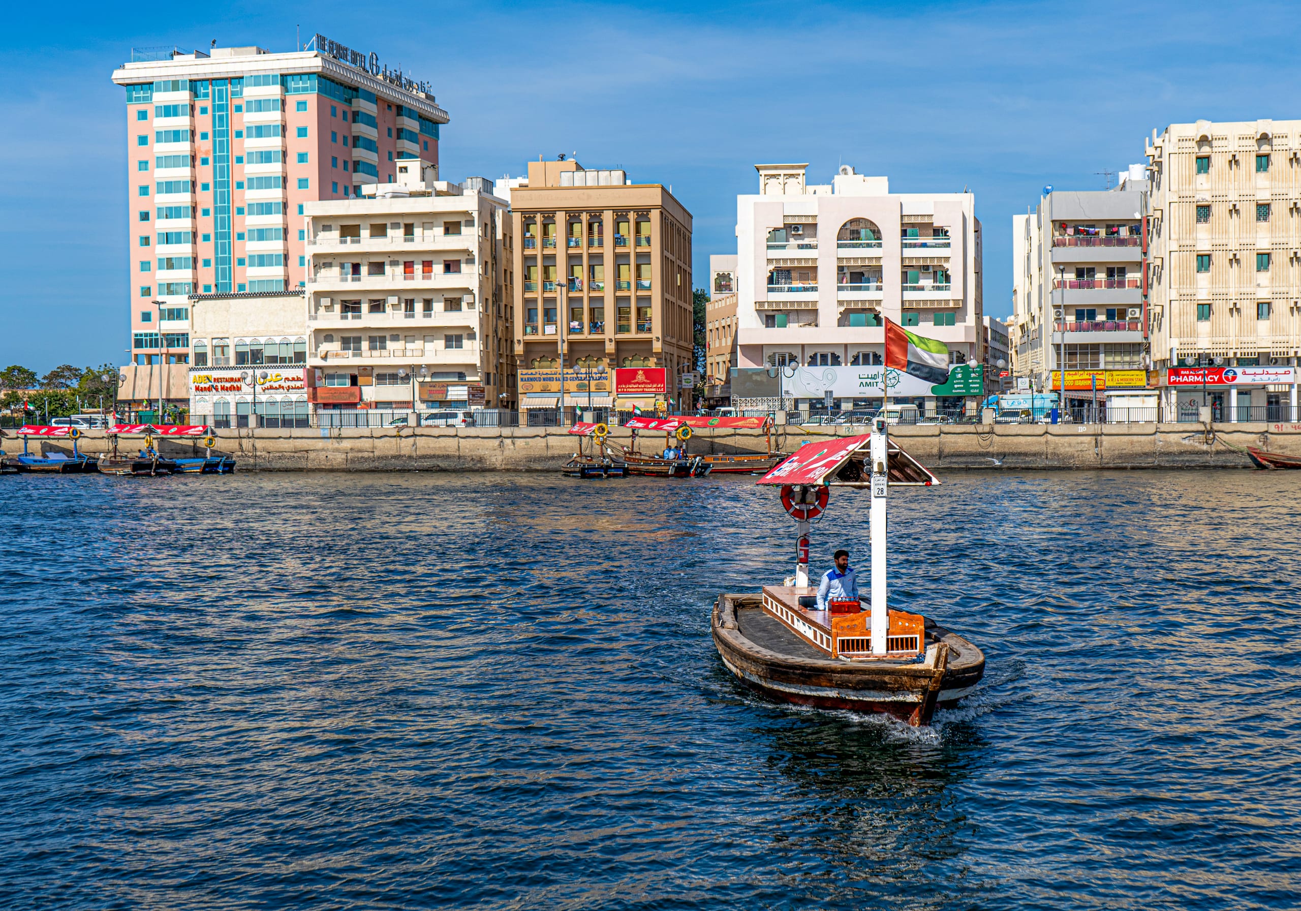 Dubai Boat SEA Building People, a fine-art photograph by Ali Abu Ras