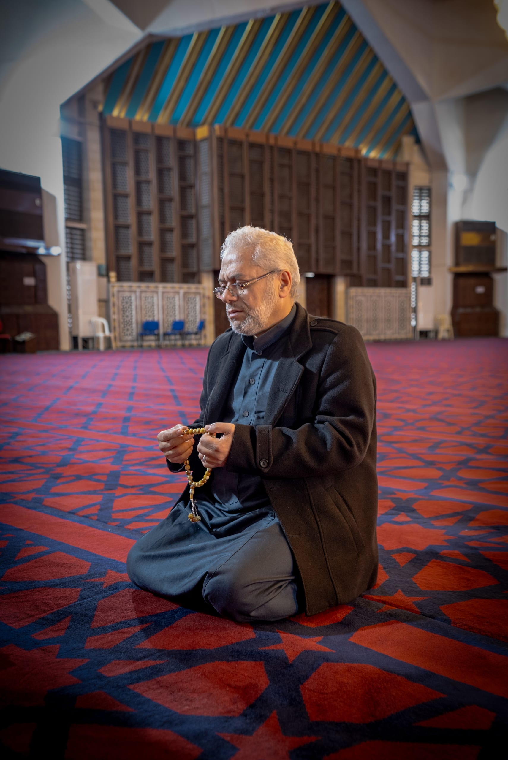 MAN OLD Masjed Pray, a fine-art photograph by Ali Abu Ras