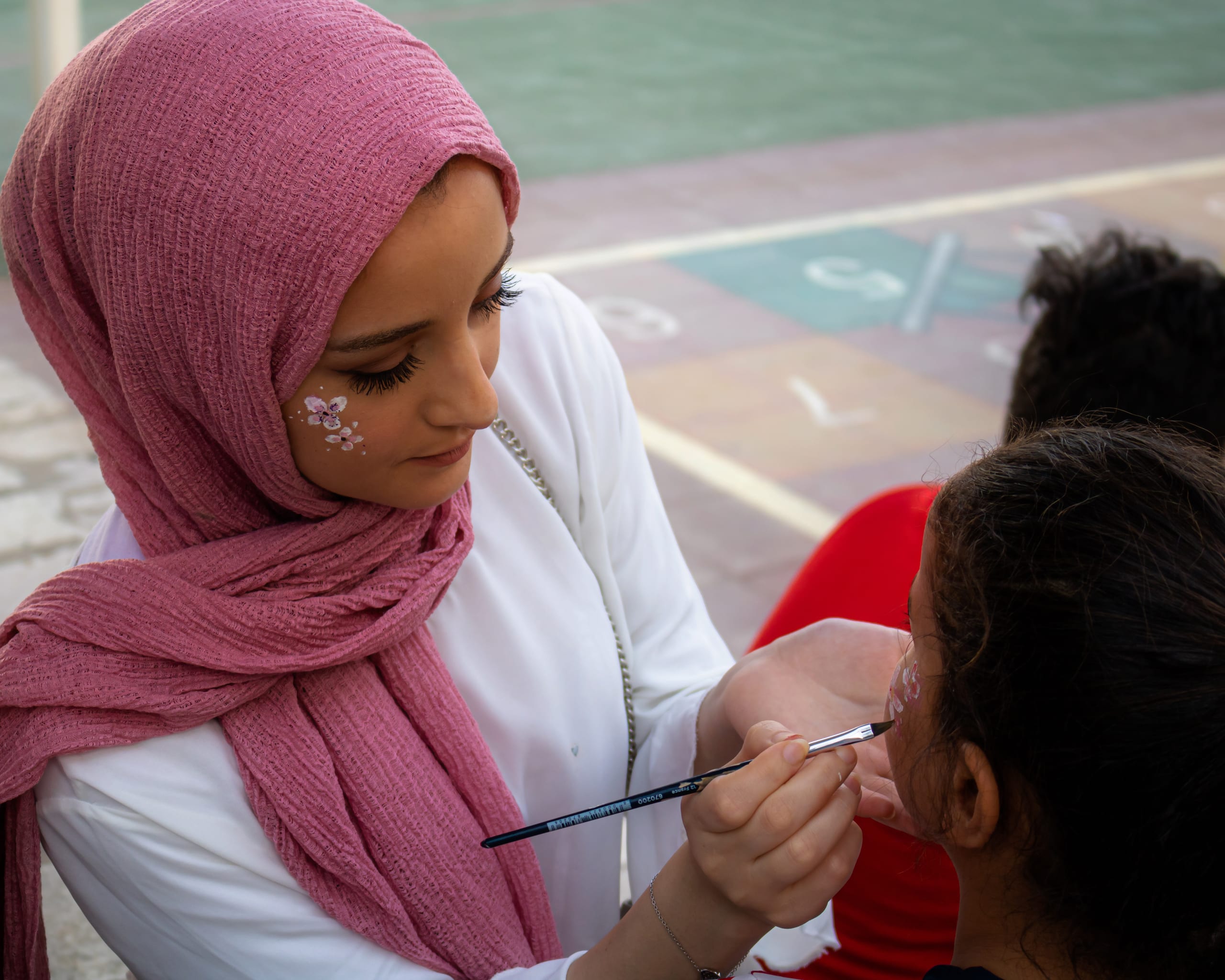 People Girles Facepainting, a fine-art photograph by Ali Abu Ras