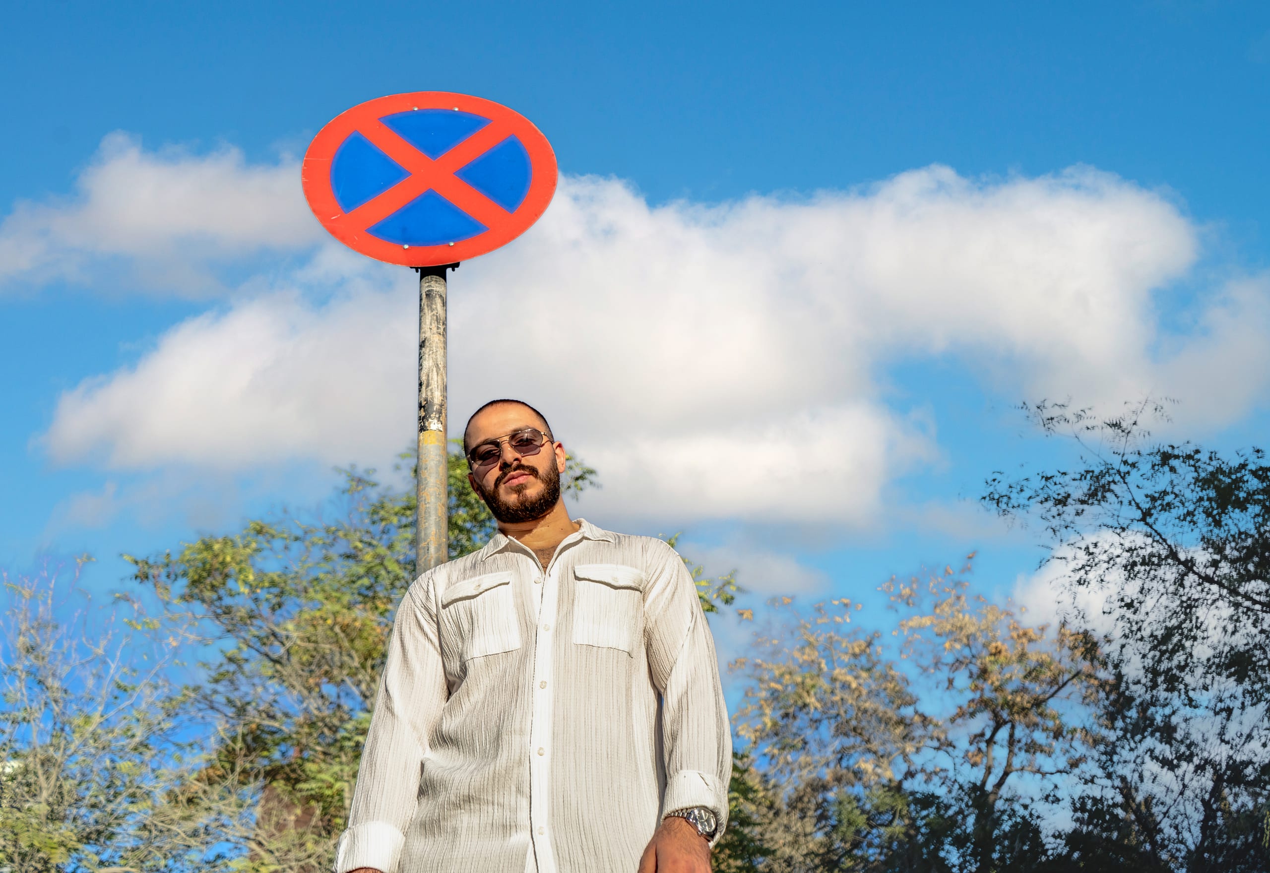 MAN Sign Stand Glass, a fine-art photograph by Ali Abu Ras