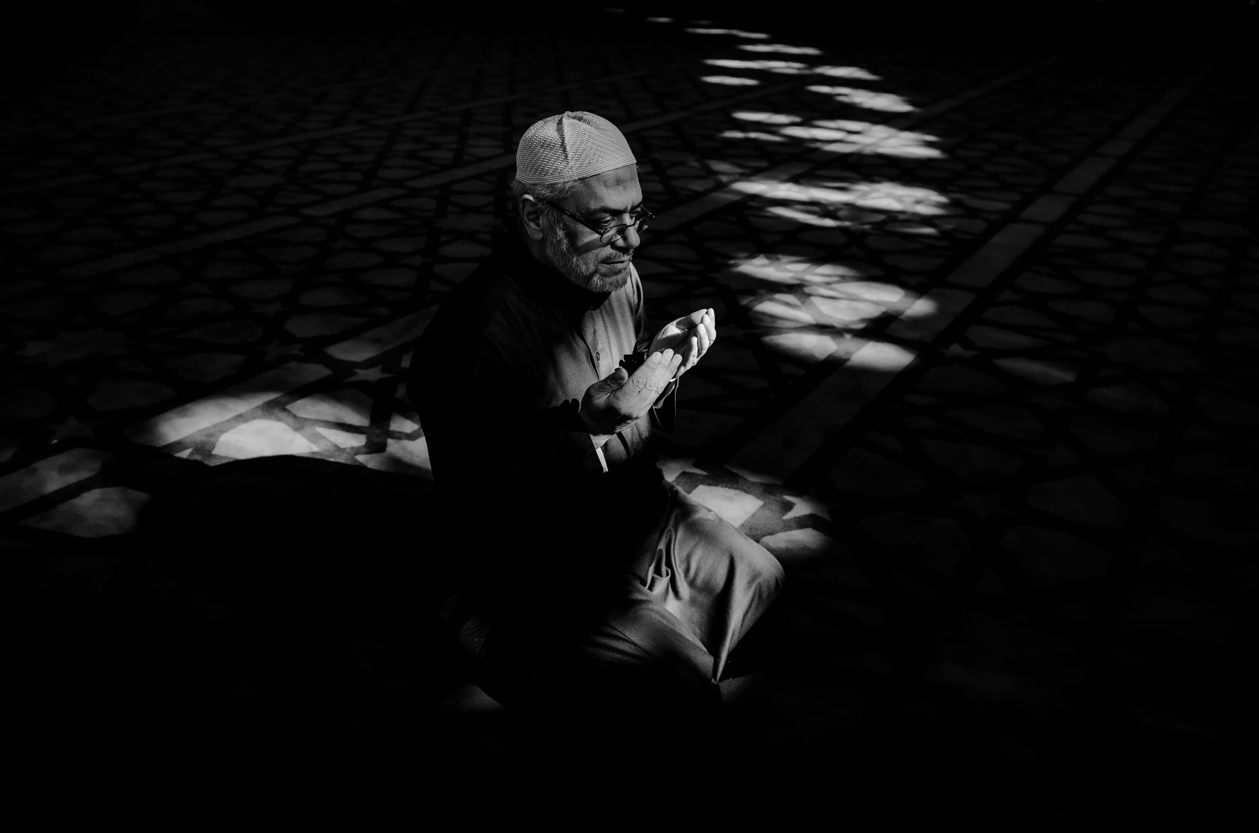 MAN Read Quran Masjid Ramadain, a fine-art photograph by Ali Abu Ras