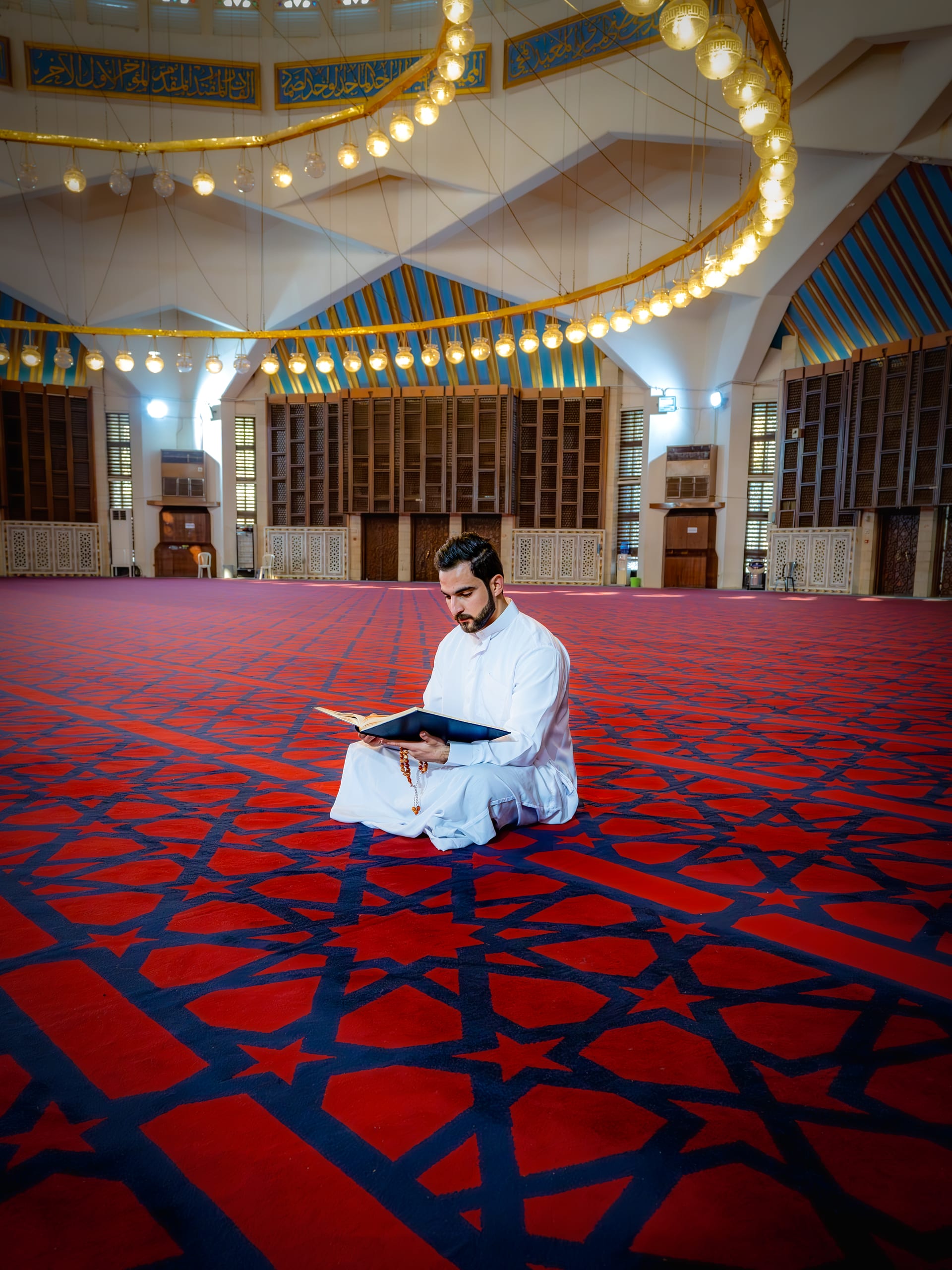 MAN Read Quran Masjid Ramadain Sunlight, a fine-art photograph by Ali Abu Ras