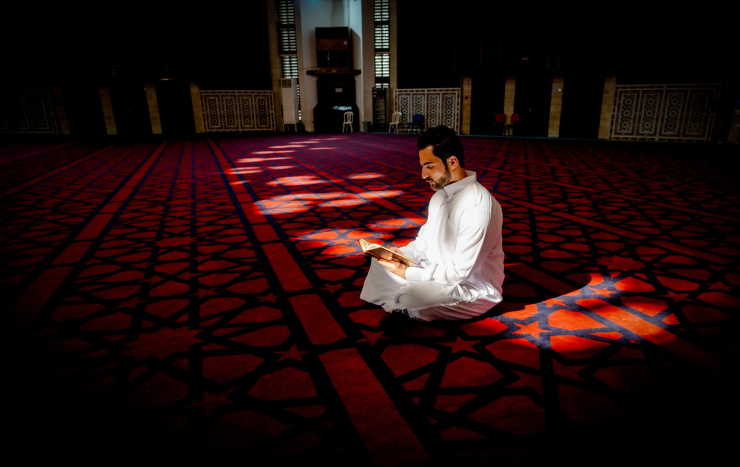 MAN Read Quran Masjid Ramadain, a fine-art photograph by Ali Abu Ras