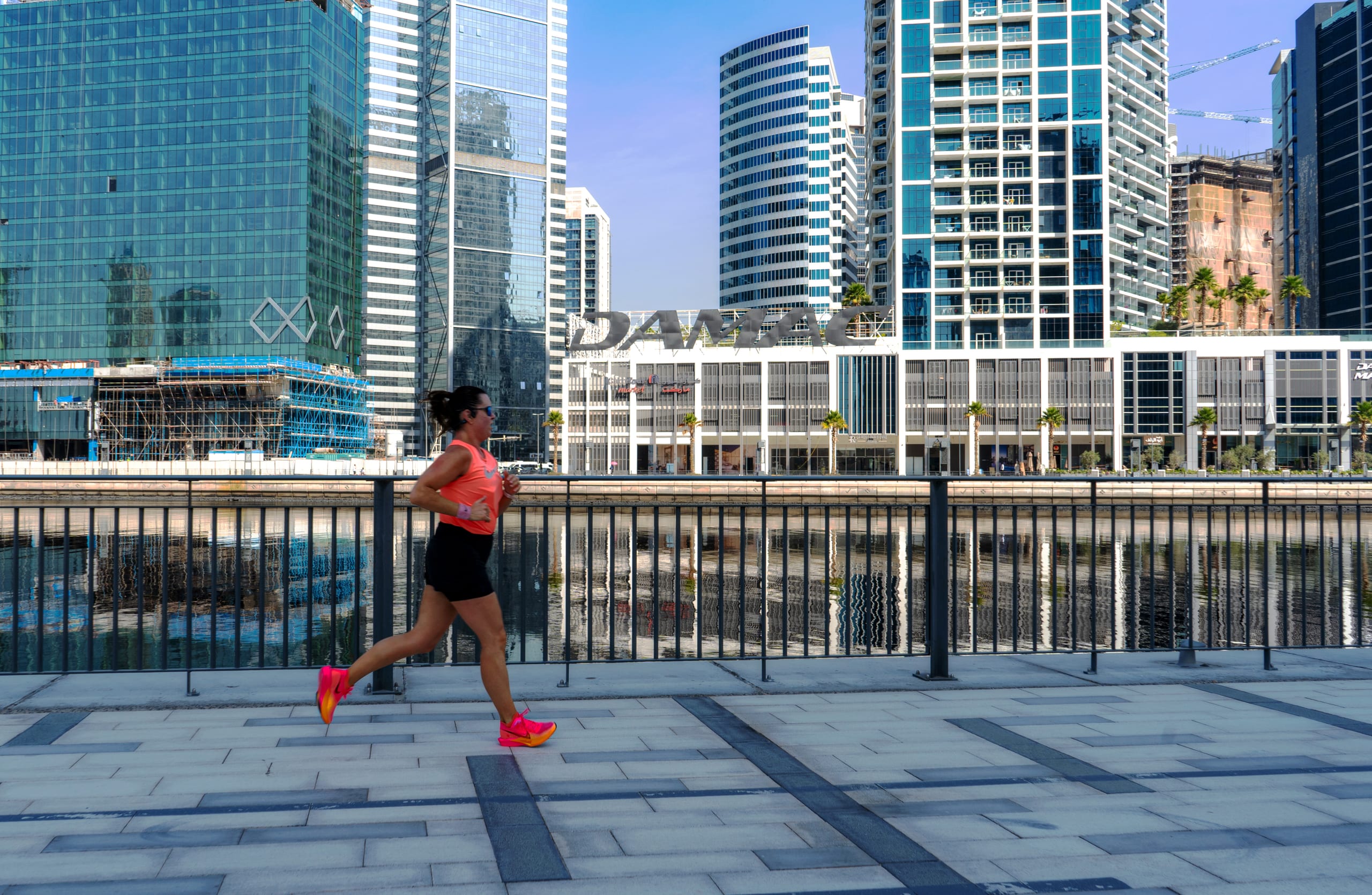 Woman RUN Road Water Dubai, a fine-art photograph by Ali Abu Ras