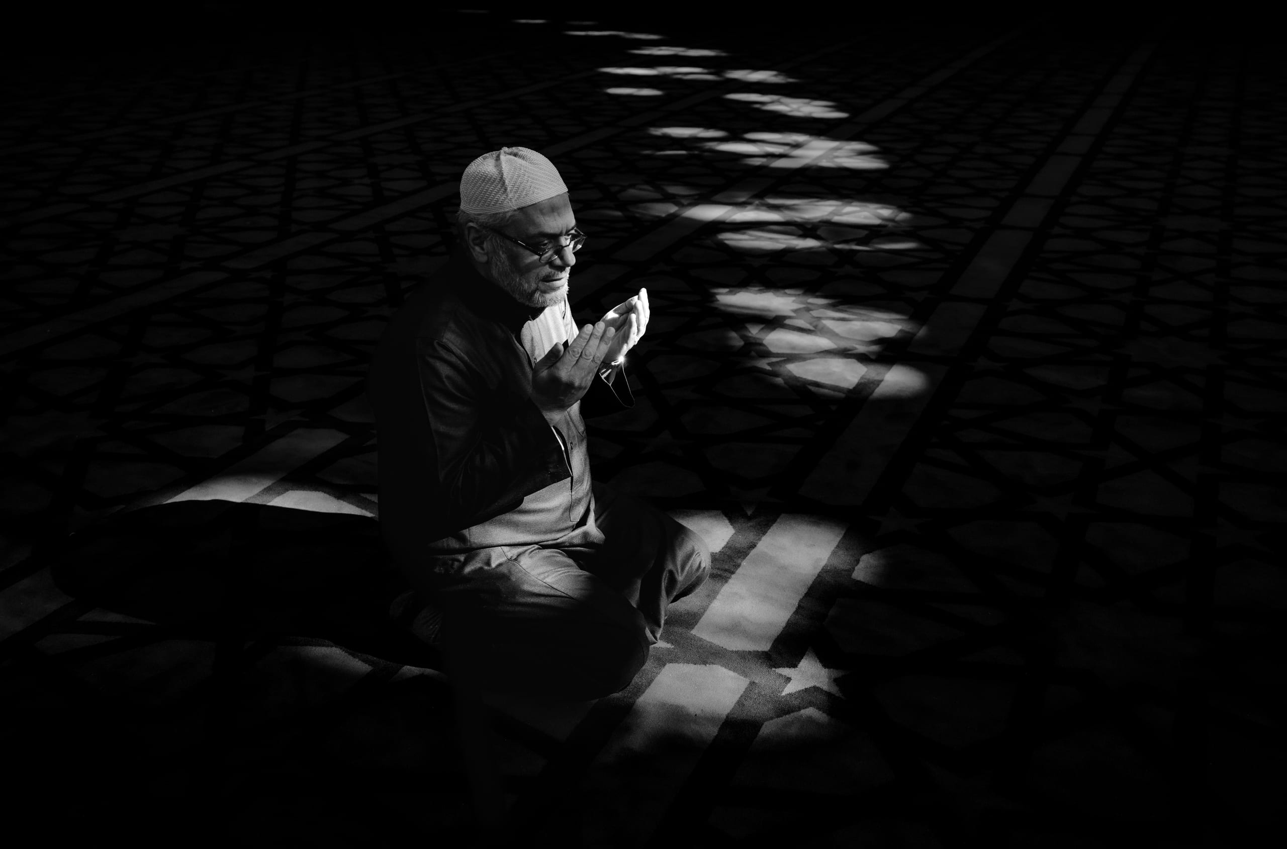 MAN Read Quran Masjid Ramadain, a fine-art photograph by Ali Abu Ras