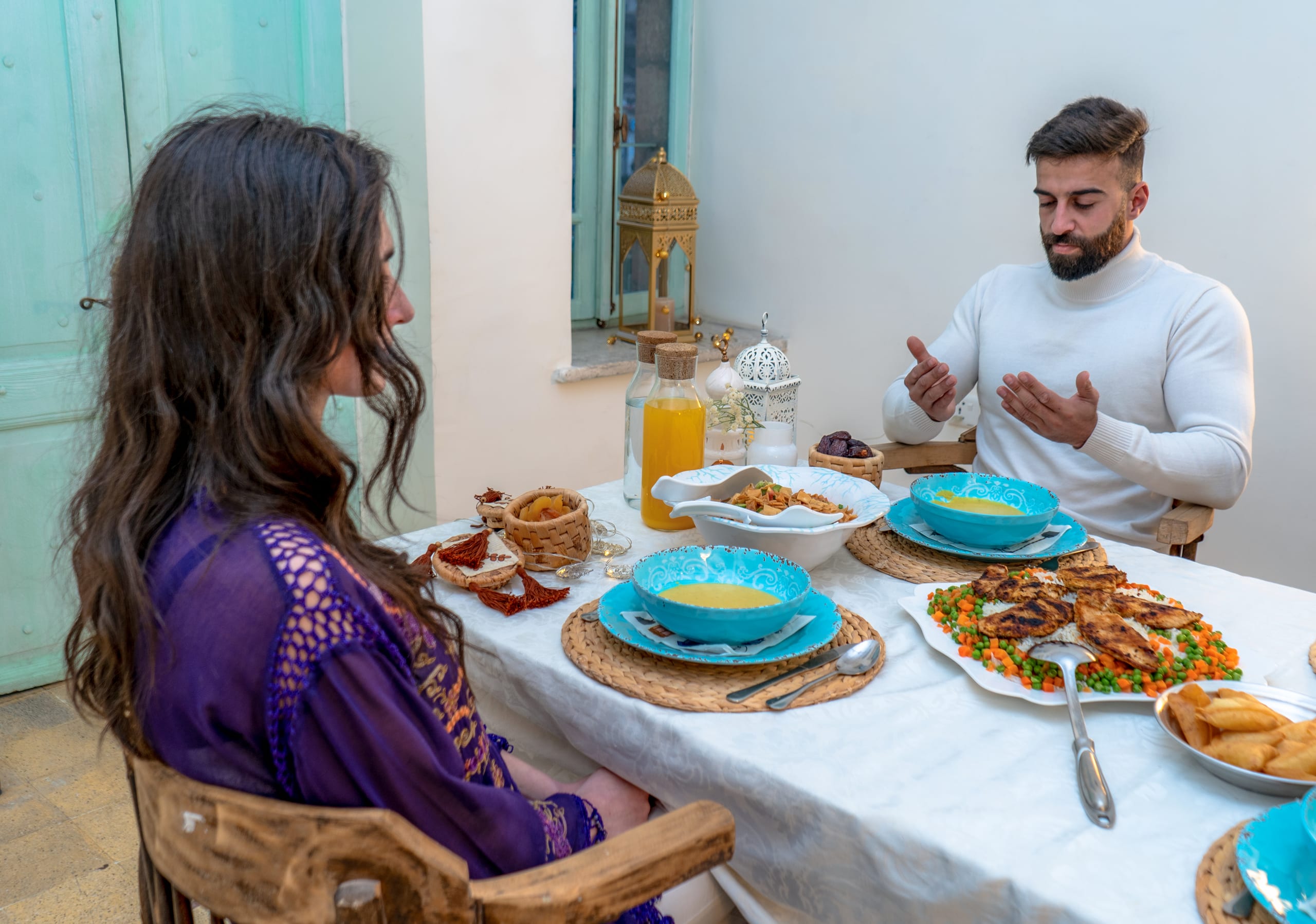 MAN Woman Pray Ramadan Eftar Sohuar, a fine-art photograph by Ali Abu Ras