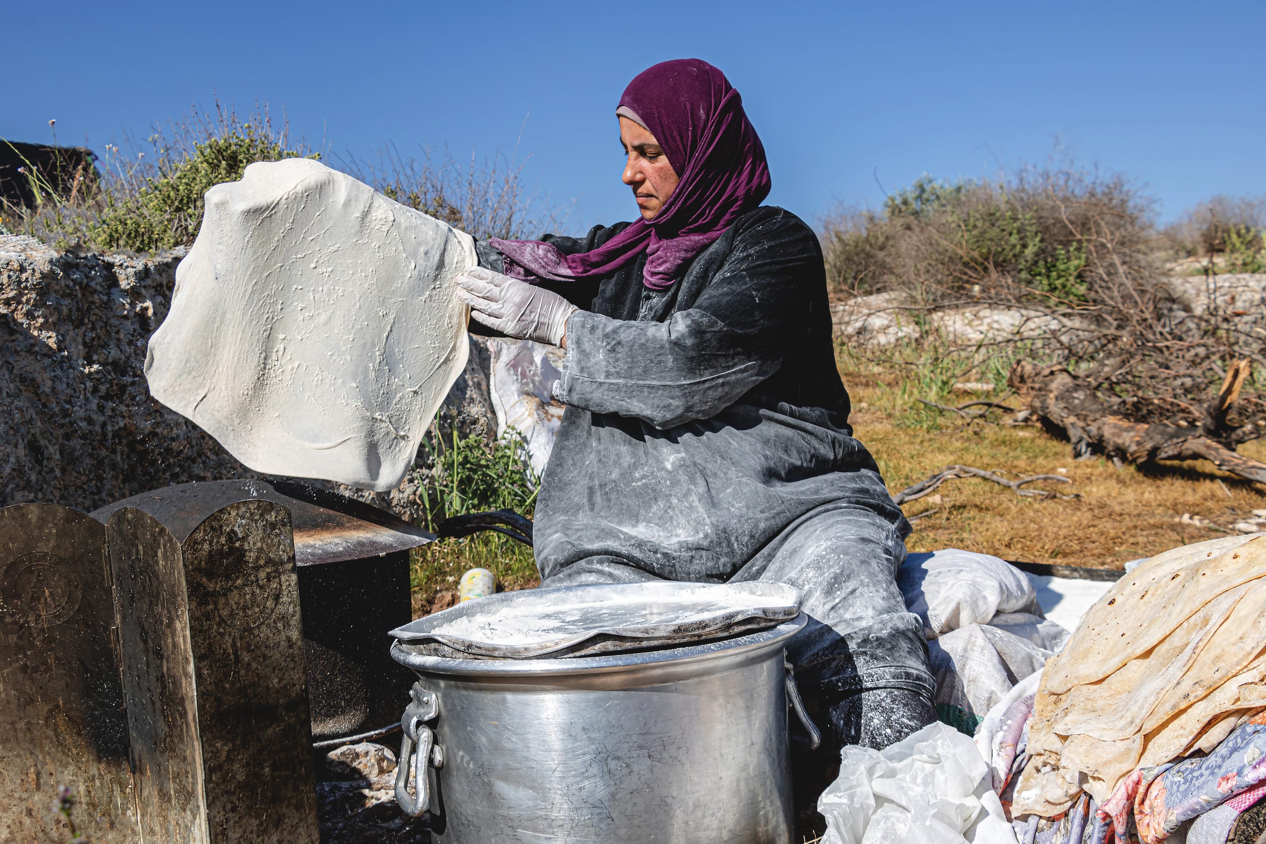 Woman Work Create Bread Outdoor Graesa, a fine-art photograph by Ali Abu Ras