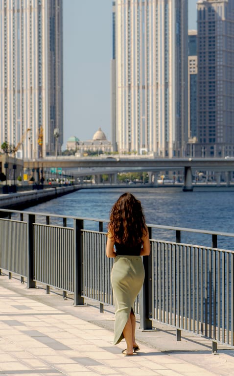 Girl Walking SEA Building, a fine-art photograph by Ali Abu Ras