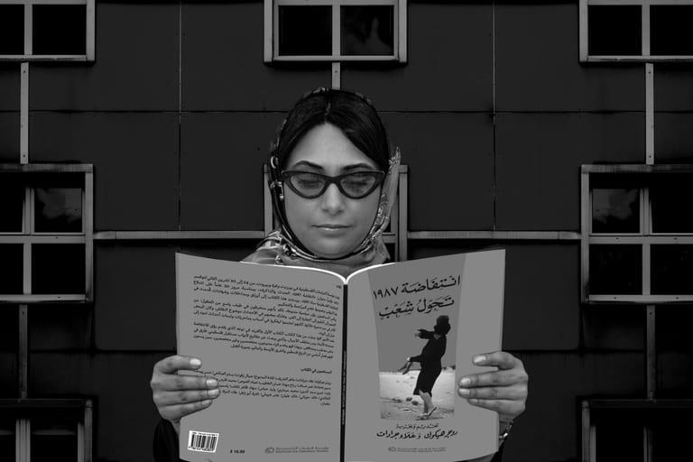 Woman Read Magazen Building Glasses, a fine-art photograph by Ali Abu Ras