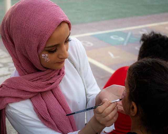 People Girles Facepainting, a fine-art photograph by Ali Abu Ras