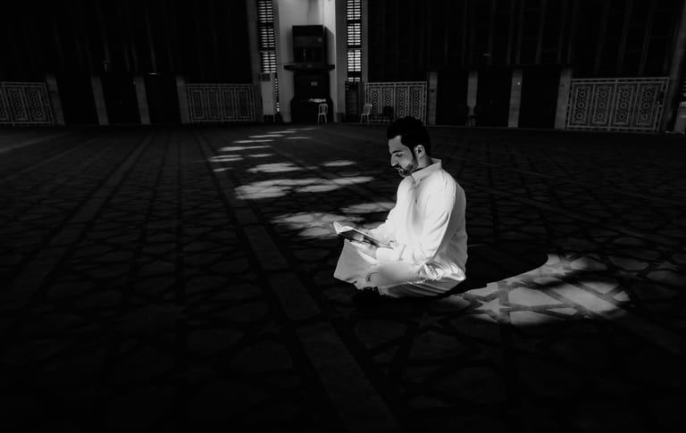 MAN Read Quran Masjid Ramadain, a fine-art photograph by Ali Abu Ras