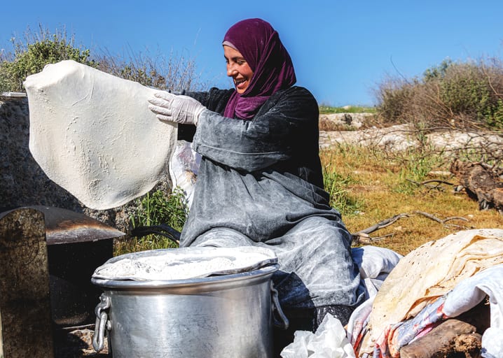 Woman Work Create Bread Outdoor Graesa, a fine-art photograph by Ali Abu Ras