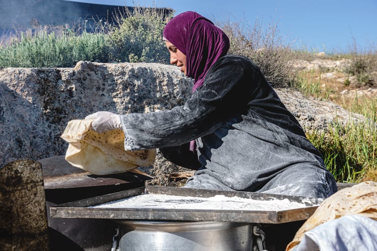 Woman Work Create Bread Outdoor Graesa, a fine-art photograph by Ali Abu Ras