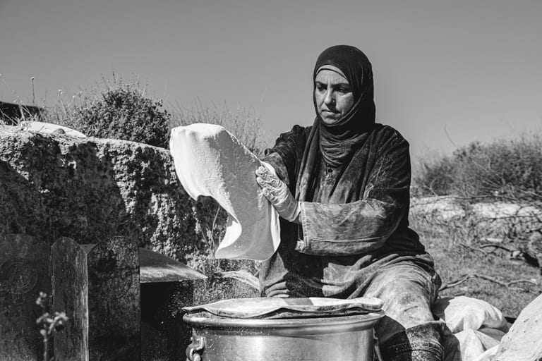 Woman Work Create Bread Outdoor Graesa, a fine-art photograph by Ali Abu Ras