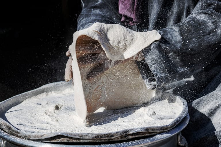 Woman Work Made Bread Graessa, a fine-art photograph by Ali Abu Ras