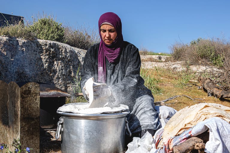 Woman Work Create Bread Outdoor Graesa, a fine-art photograph by Ali Abu Ras