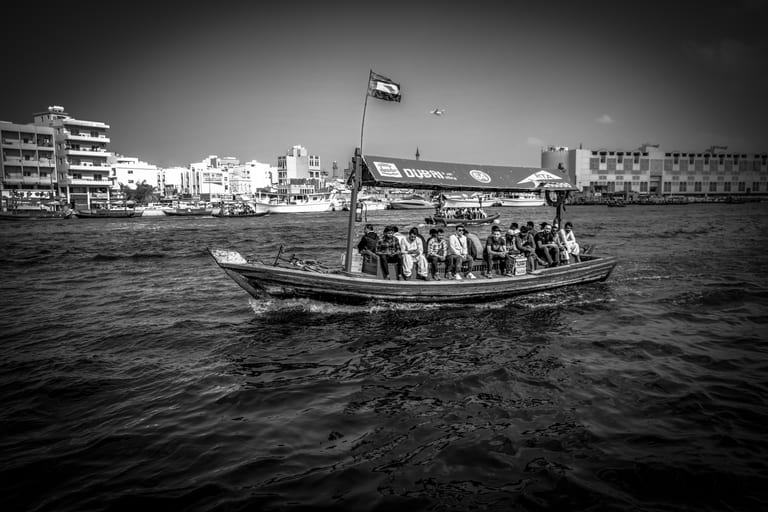 Dubai SEA Boat People Airplan Cloud, a fine-art photograph by Ali Abu Ras