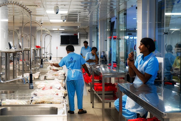 Market Dubai People Fish Cleaner, a fine-art photograph by Ali Abu Ras
