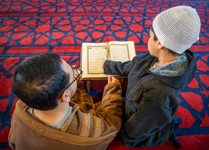 BOY Father Masjed Quran, a fine-art photograph by Ali Abu Ras