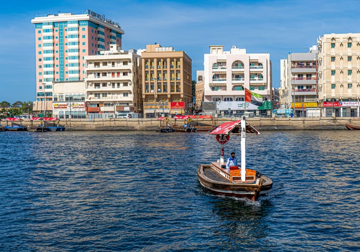 Dubai Boat SEA Building People, a fine-art photograph by Ali Abu Ras