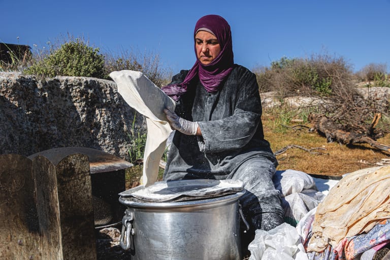Woman Work Create Bread Outdoor Graesa, a fine-art photograph by Ali Abu Ras