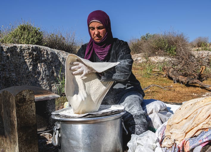 Woman Work Create Bread Outdoor Graesa, a fine-art photograph by Ali Abu Ras