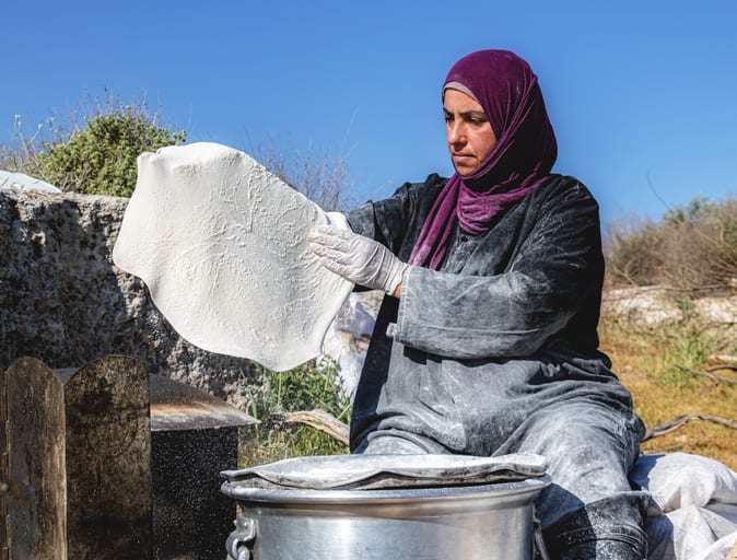 Woman Work Create Bread Outdoor Graesa, a fine-art photograph by Ali Abu Ras